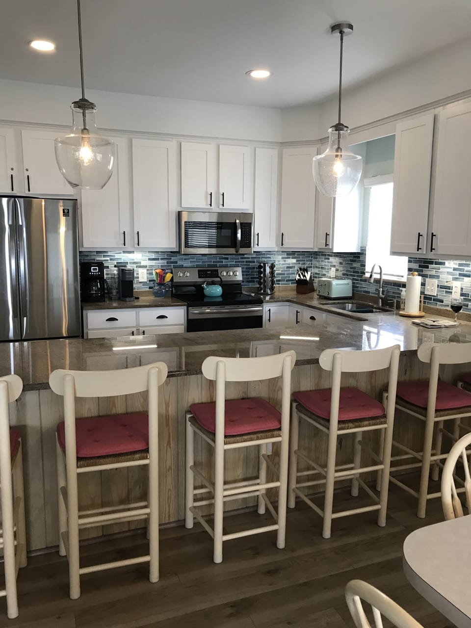 Six comfy stools at the counter, new cabinets & flooring & backsplash! 