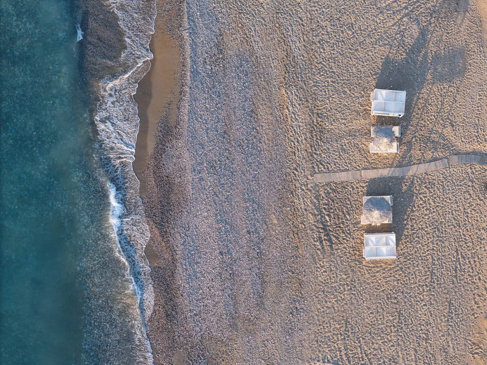 Enjoy your own private stretch of sand with sunbeds and umbrellas reserved just for you