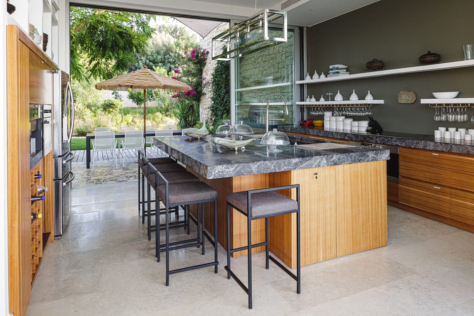 The fully equipped kitchen boasts state-of-the-art appliances, ensuring a seamless self-catered stay, while the adjacent island makes an ideal spot for your morning coffee.