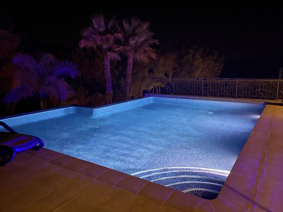 Pool at night, with colour changing pool lights