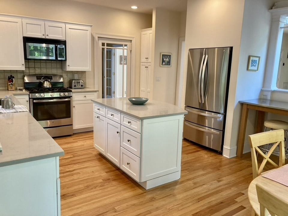 Center island and new stainless refrigerator w/fresh water dispenser inside uni