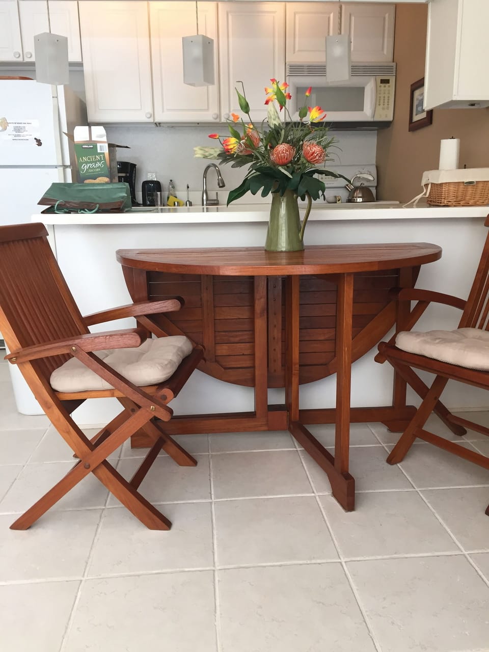 The Teak Dining Room table unfolds to seat 4 guests.