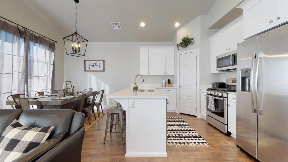 Fully stocked gourmet kitchen featuring stainless steel appliances