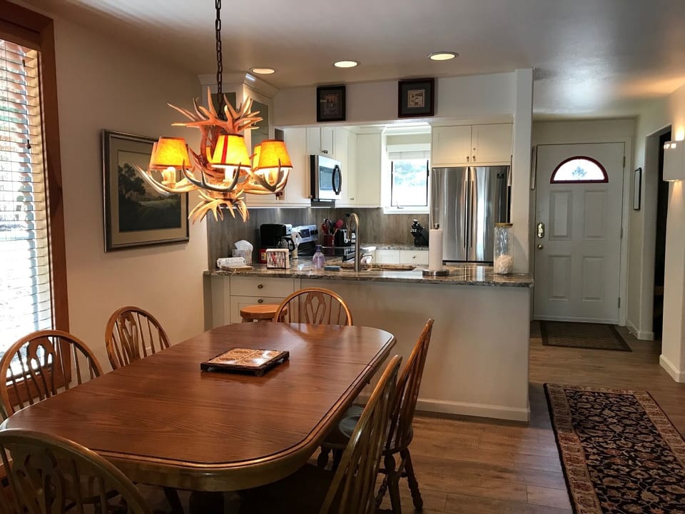 Fully-equipped kitchen and dining area.  Extra chairs in the coat closet.