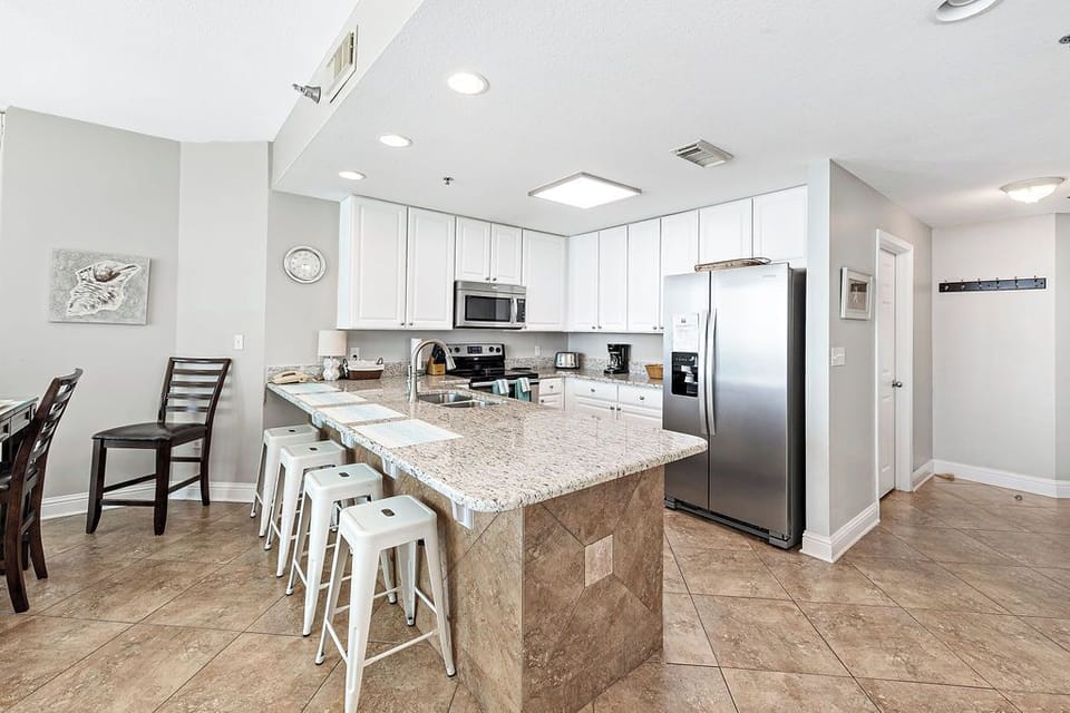 Fully-stocked kitchen w/granite counter tops and stainless steel appliances.