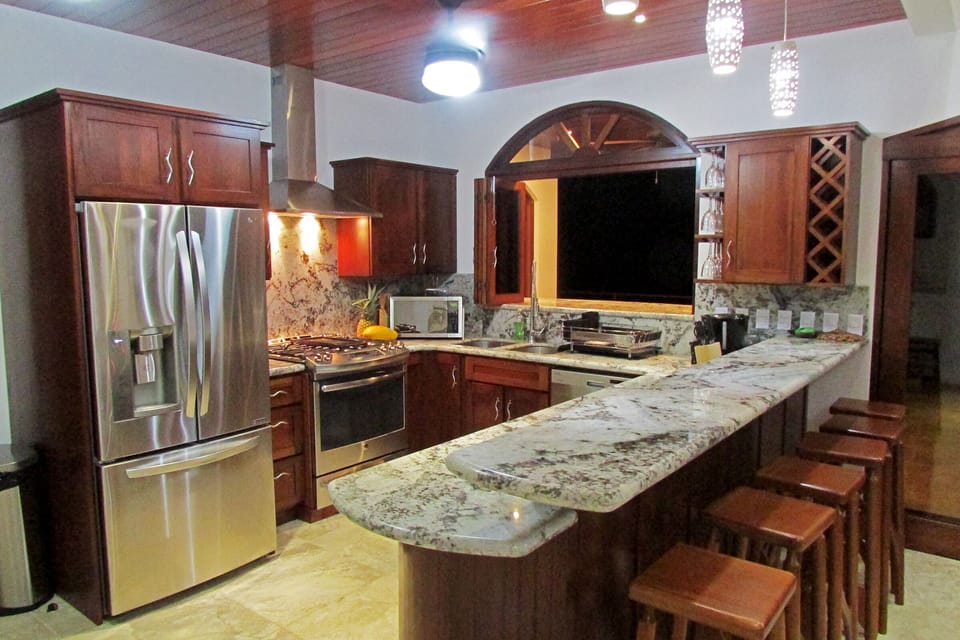 Gourmet kitchen and bar with pass thru window to the outside dinning and bar