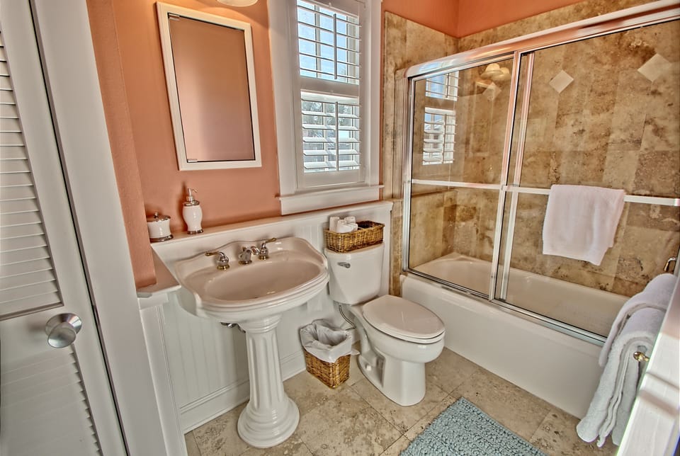 queen suite bathroom upstairs. Marble floors, limestone showers, pedestal sinks