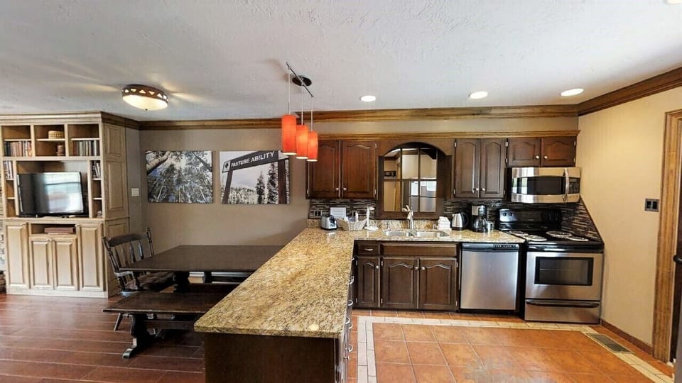 Your open-concept space blends rustic charm with modern convenience—granite countertops, stainless appliances, and a cozy dining nook perfect for shared meals and cherished memories.