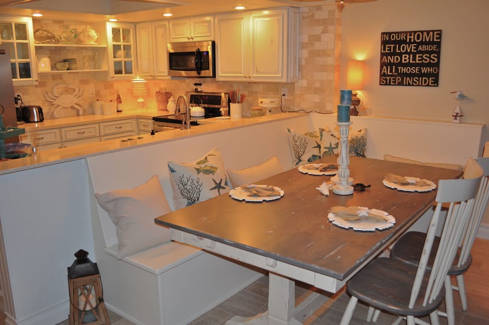 Large dining room table with chairs and bench seating.