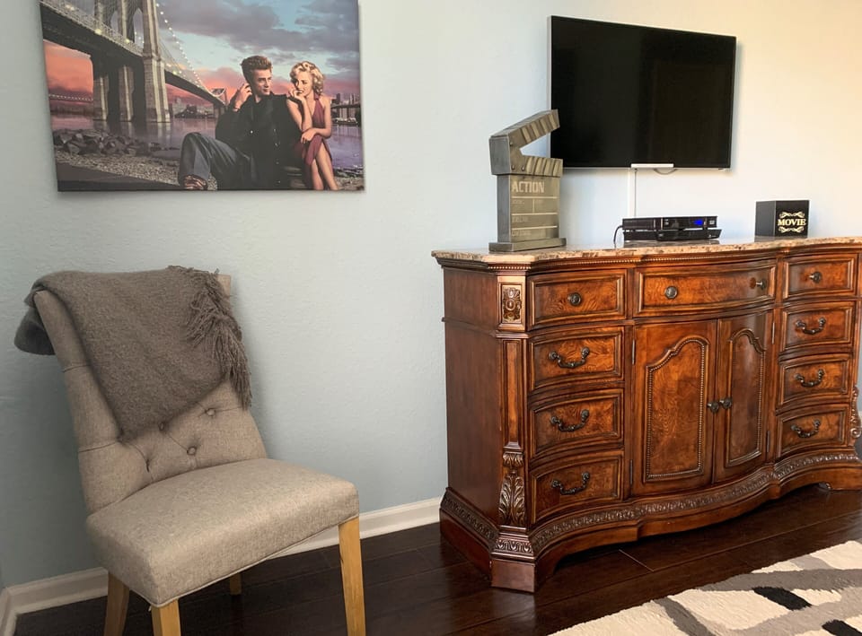 Primary bedroom chair, dresser, flat screen TV 