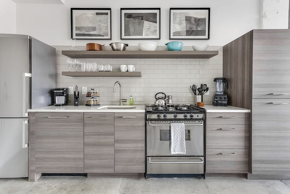 A full picture of the kitchen of this Ponce City Flat, complete with modern appliances and ample cabinetry.