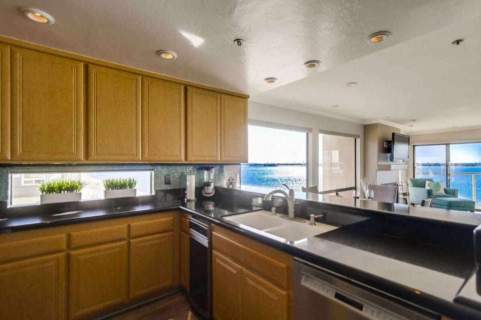 Fully equipped kitchen with stainless steel appliances include a dishwasher