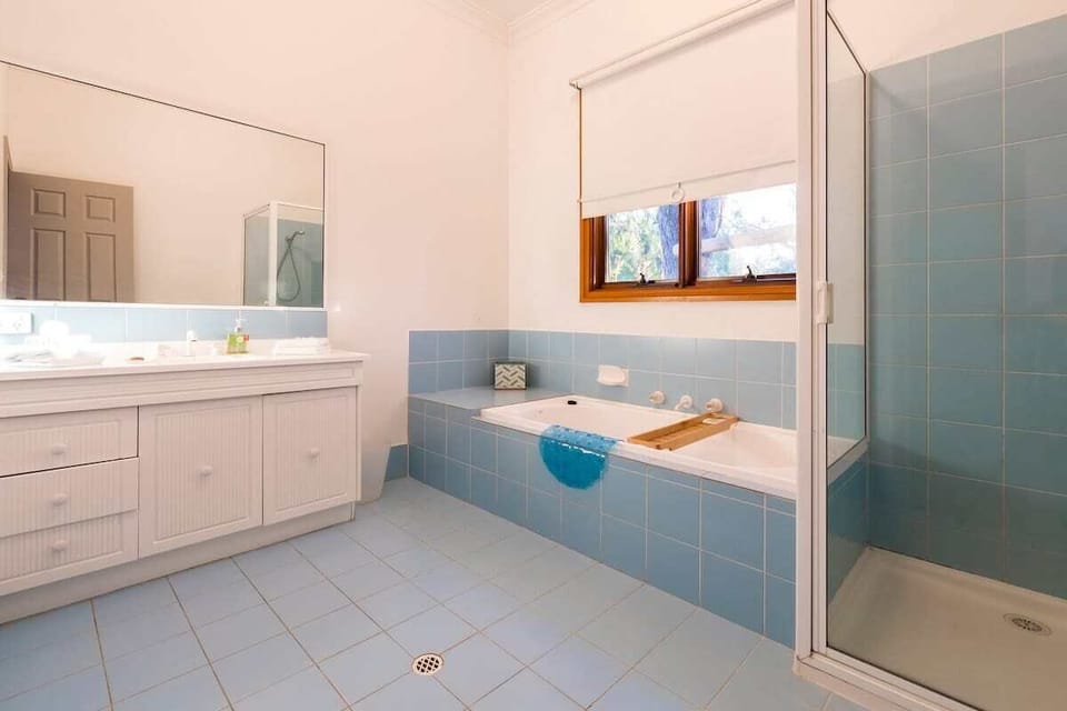 Unwind in the family bathroom with a full-sized bath for long soaks, a separate shower, and a generous vanity.