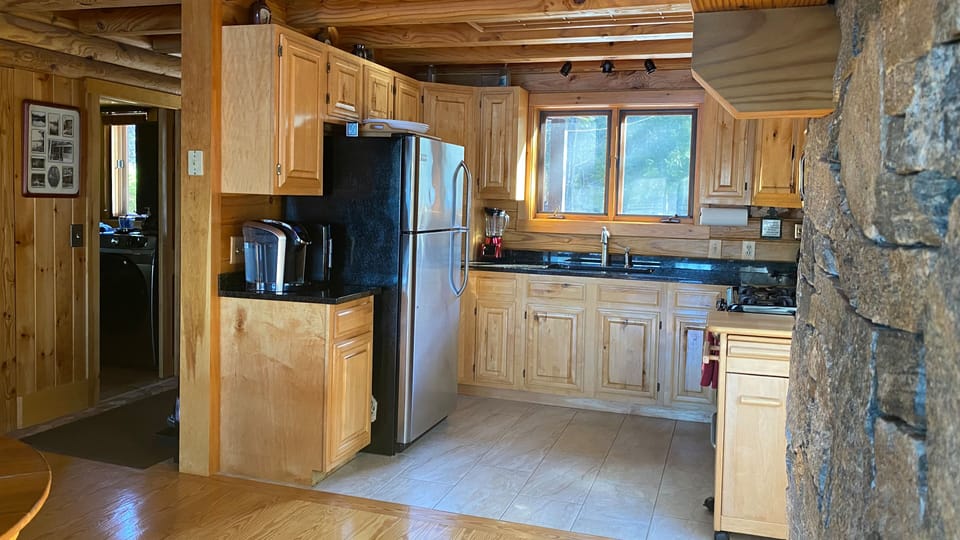 Kitchen view 1: Keurig Coffee Maker, Refrigerator, and granite countertops.
