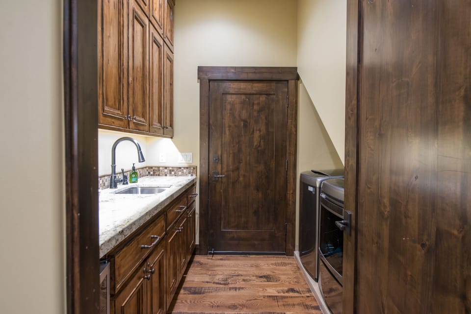 Laundry room with washer, dryer, and mini fridge