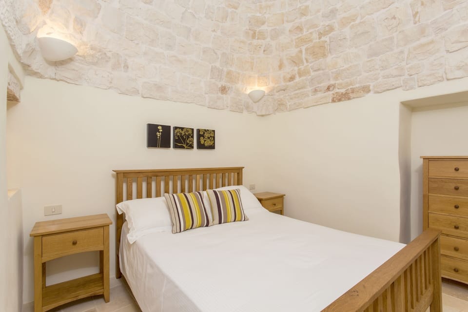 Bedroom with oak furniture and beautiful stone roof