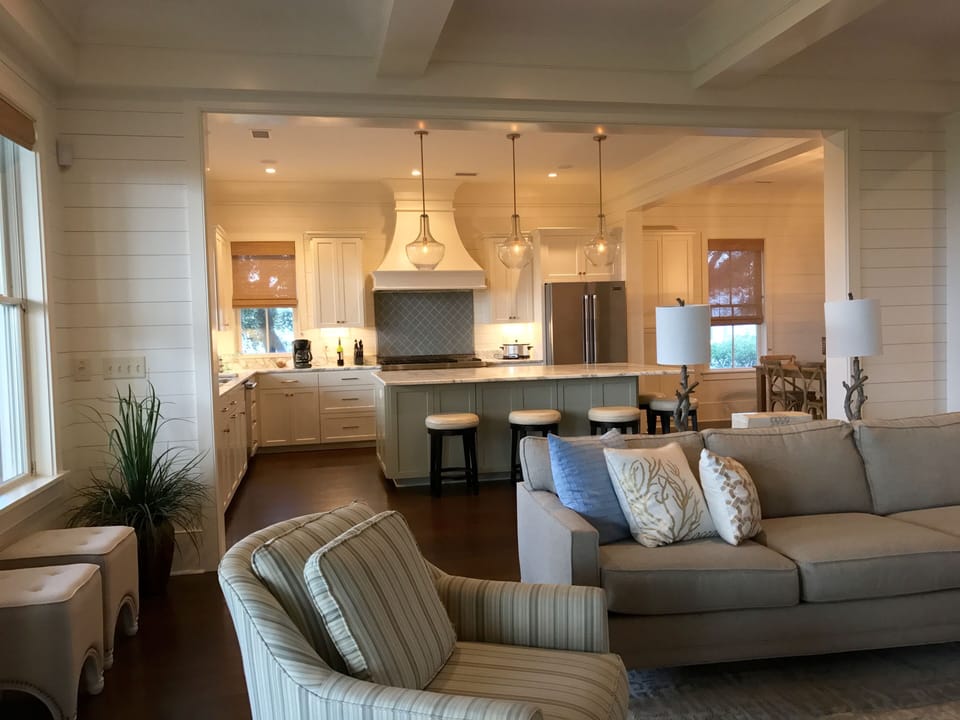 large sectional sofa and 2 swivel chairs. Foot stools serve double duty as seats