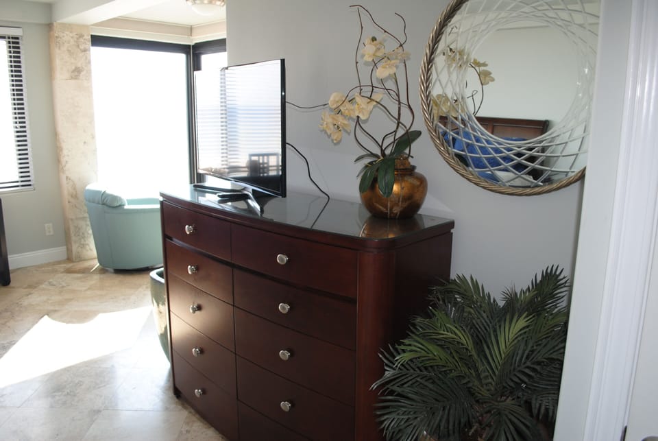 Master bedroom with a full size dresser with drawers and flat screen tv