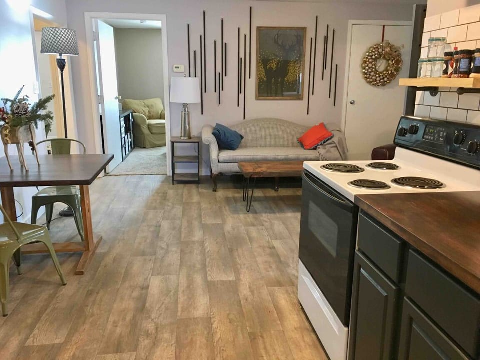 Looking through kitchen into living space and towards bedrooms.