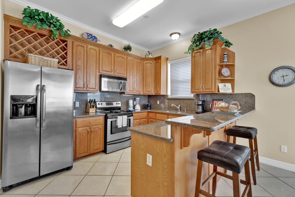Fully equipped kitchen offers plenty of space for cooking meals, gathering for snacks, and starting beach days with ease
