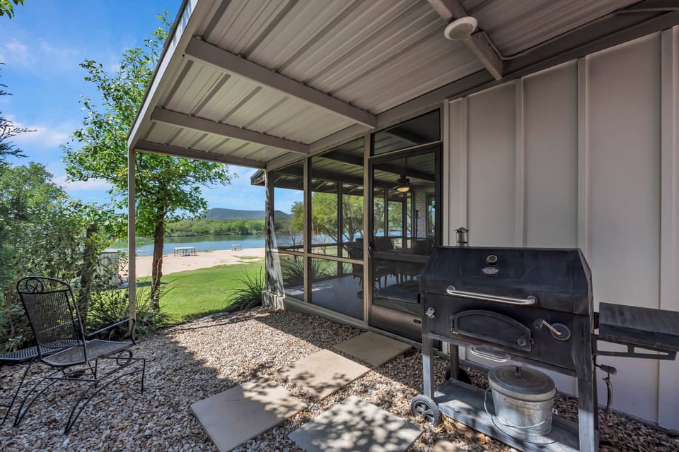 Covered grilling patio beside screened porch allows great views in all weather
