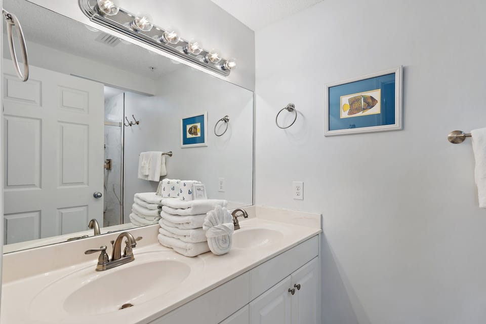 A fresh bathroom with a vanity and plush towels.