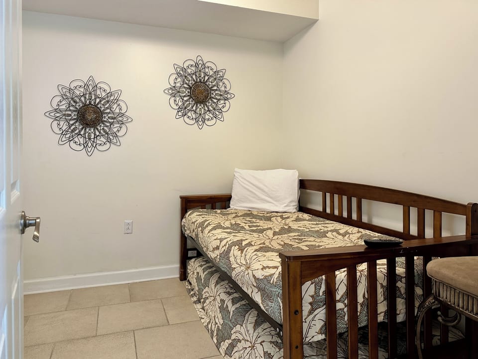 3rd bedroom with 2 twin beds, closet and window.