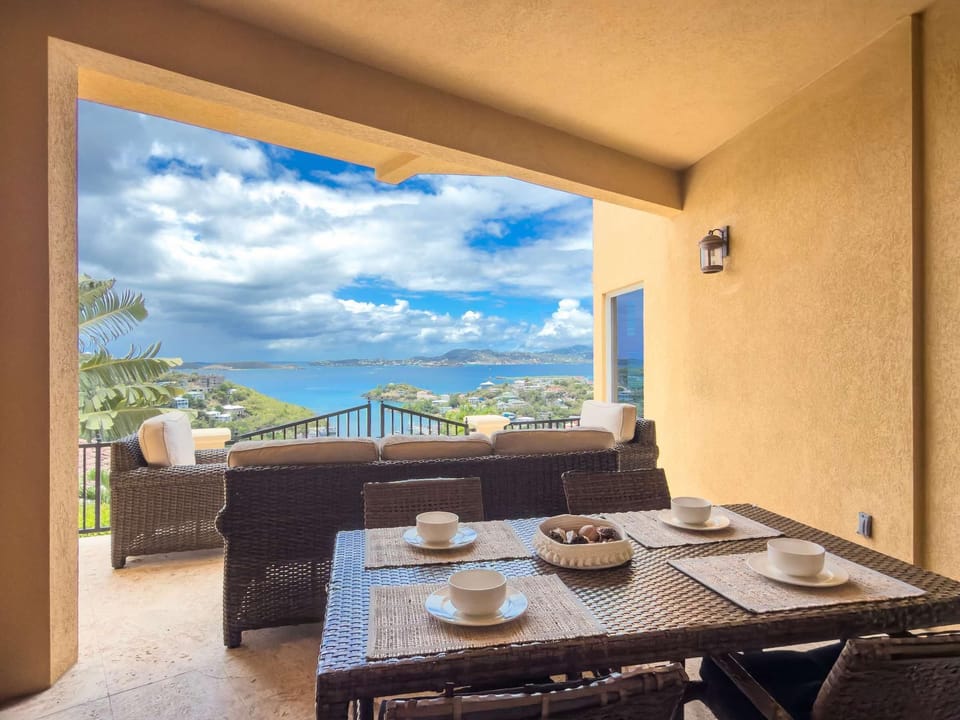 Covered patio with stunning ocean and mountain views