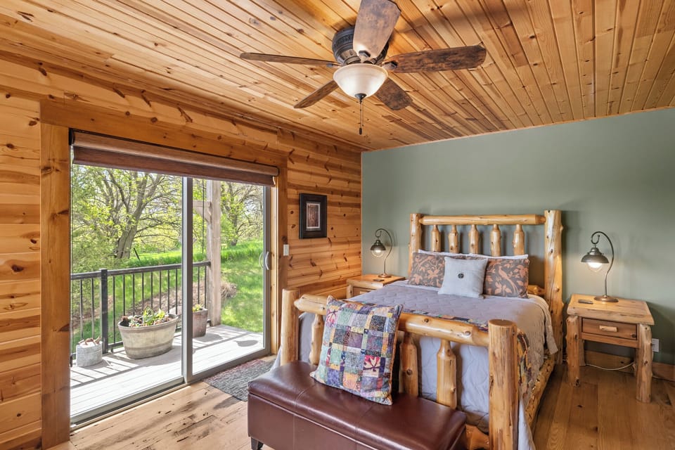Main floor queen bed with adjoining deck