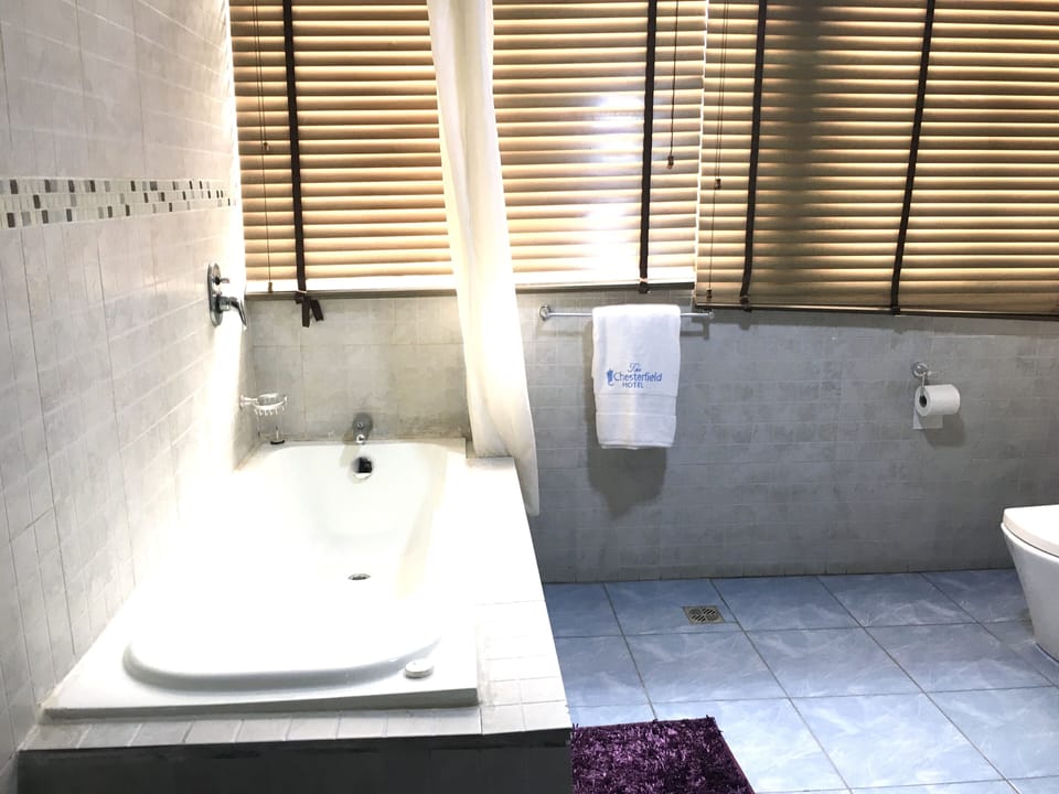 Room (Queens) | Bathroom | Deep soaking tub, designer toiletries, bathrobes, towels