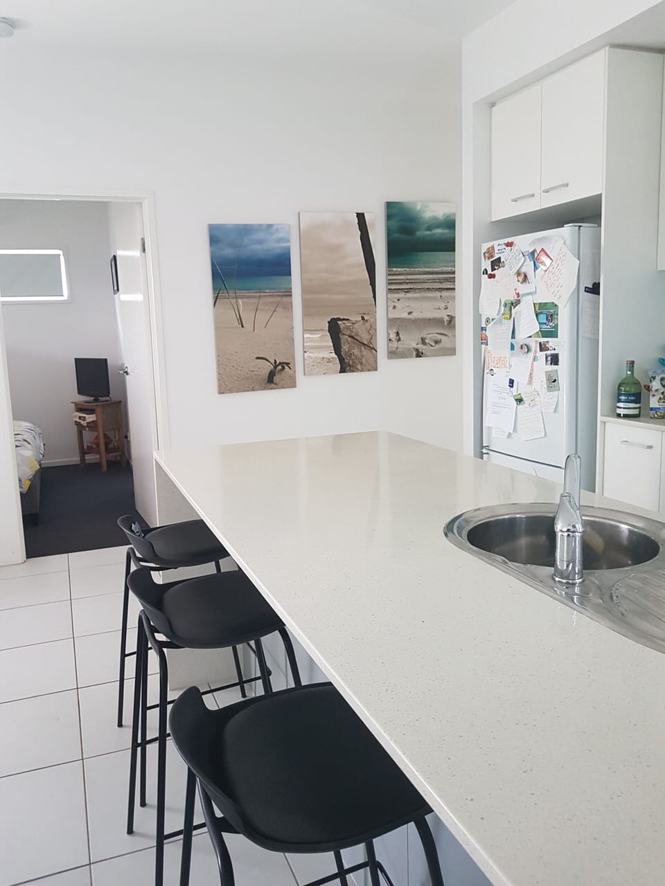 Kitchen with view  of the main bedroom in the background