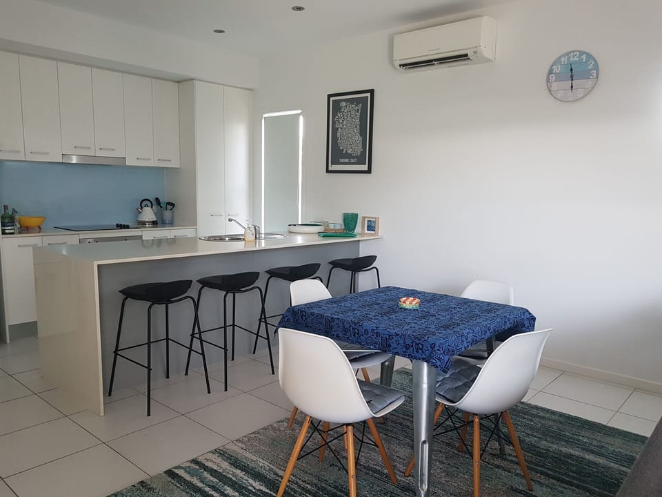 Open plan dining, kitchen and lounge.