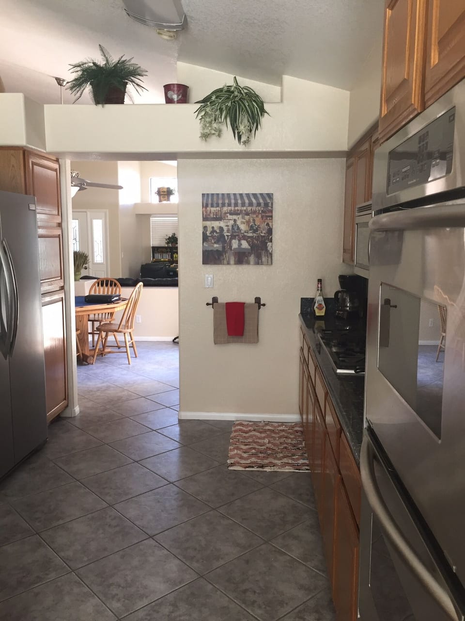 Tiled kitchen looking to dining/ poker table