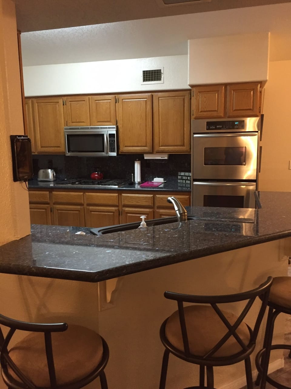 Breakfast bar to Kitchen. GRANITE counter tops, DUAL WALL OVENS, SPACIOUS.