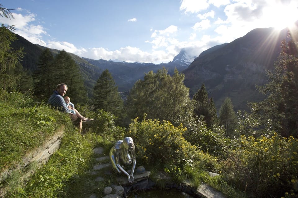 Large private garden in front of chalet with pond