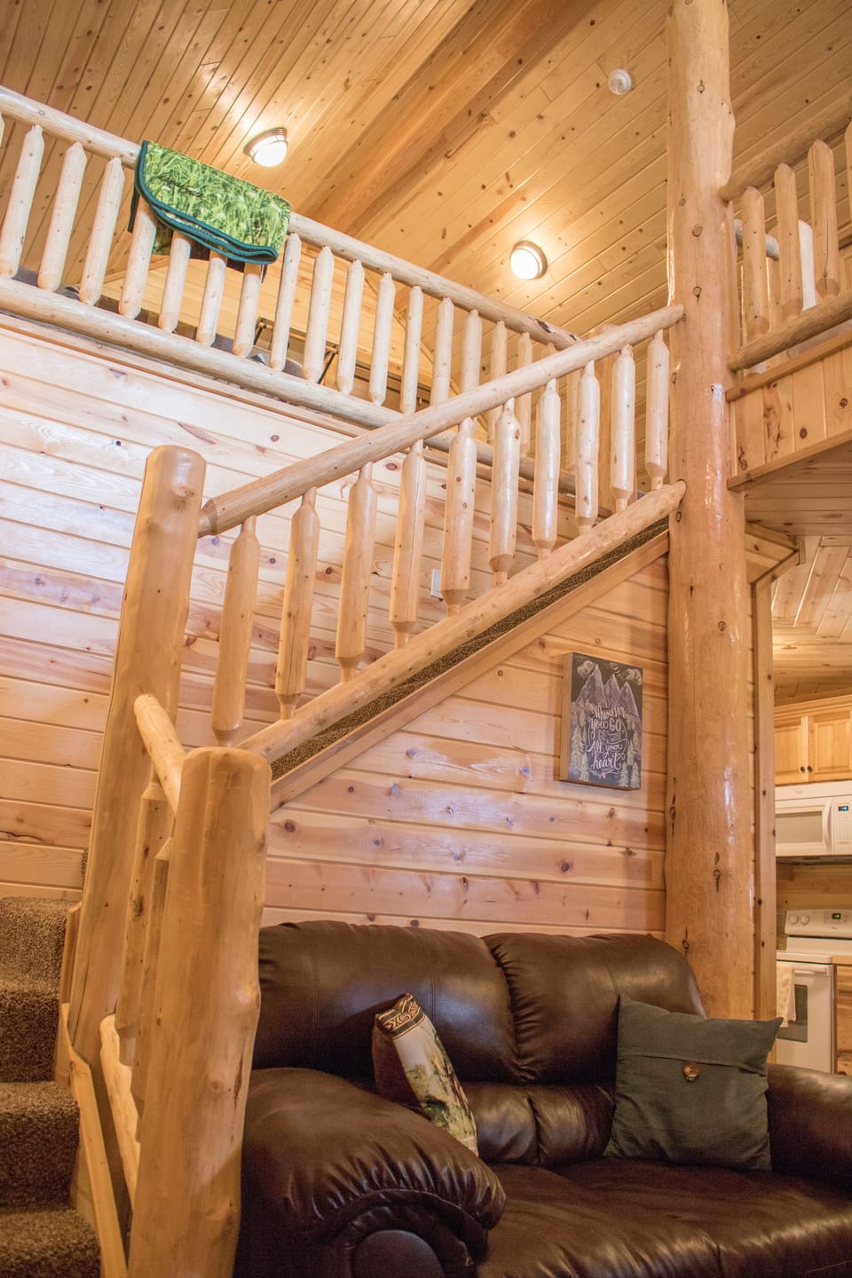 Custom log railings and pine throughout make cabin one of a kind!