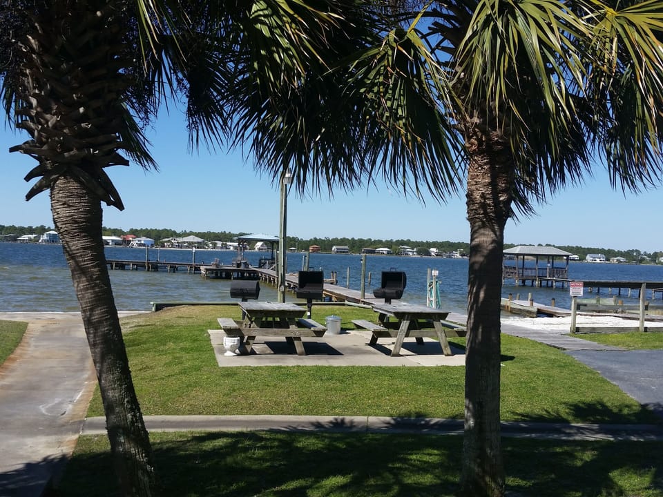 Very well lit grilling area and picnic tables with view of Little Lagoon 