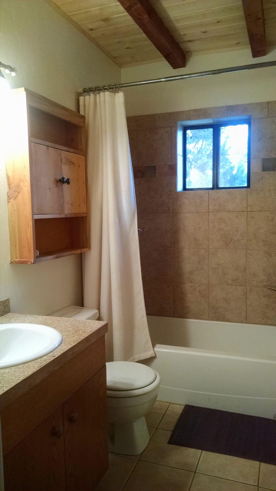 Bright bathroom with views out to alpine field; soak in the tub.