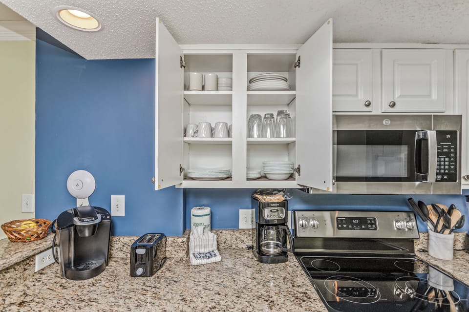 Kitchen equipped with essential cooking equipment