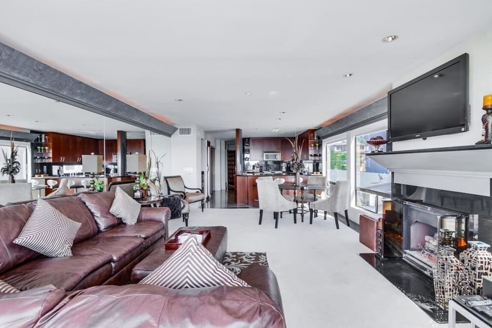 Living room with gas fireplace, TV with cable, and dining area. Now with a foldout sleeper sofa, full size!