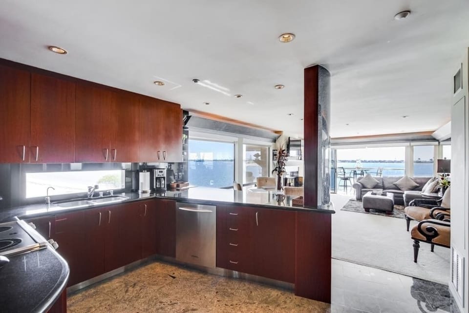 Kitchen fully equipped for meals at home stainless steel appliances including a dishwasher