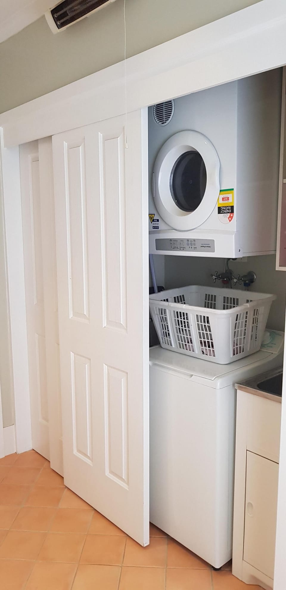Laundry in cupboards in bathroom