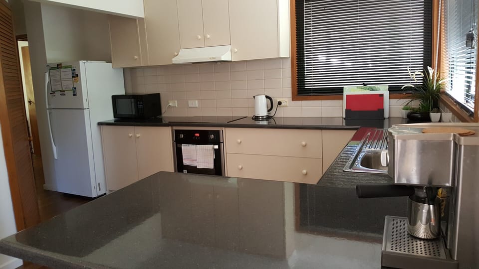 Gastronomic delight: Well-equipped kitchen, modern stove, dedicated coffee area. 