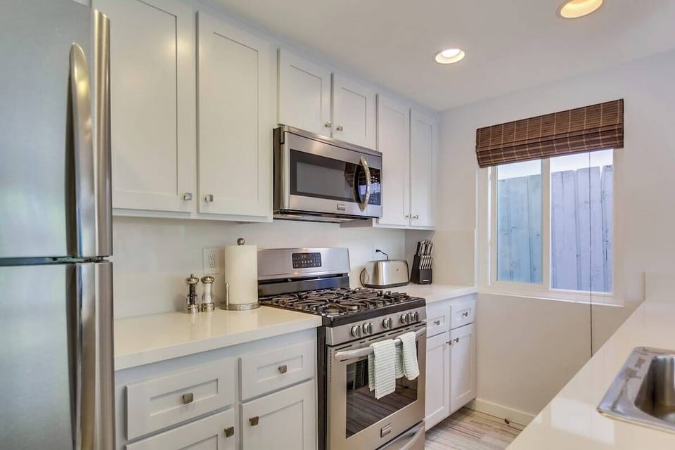 Kitchen with stainless steel appliances, gas stove, sink, toaster, coffee maker, dishwasher