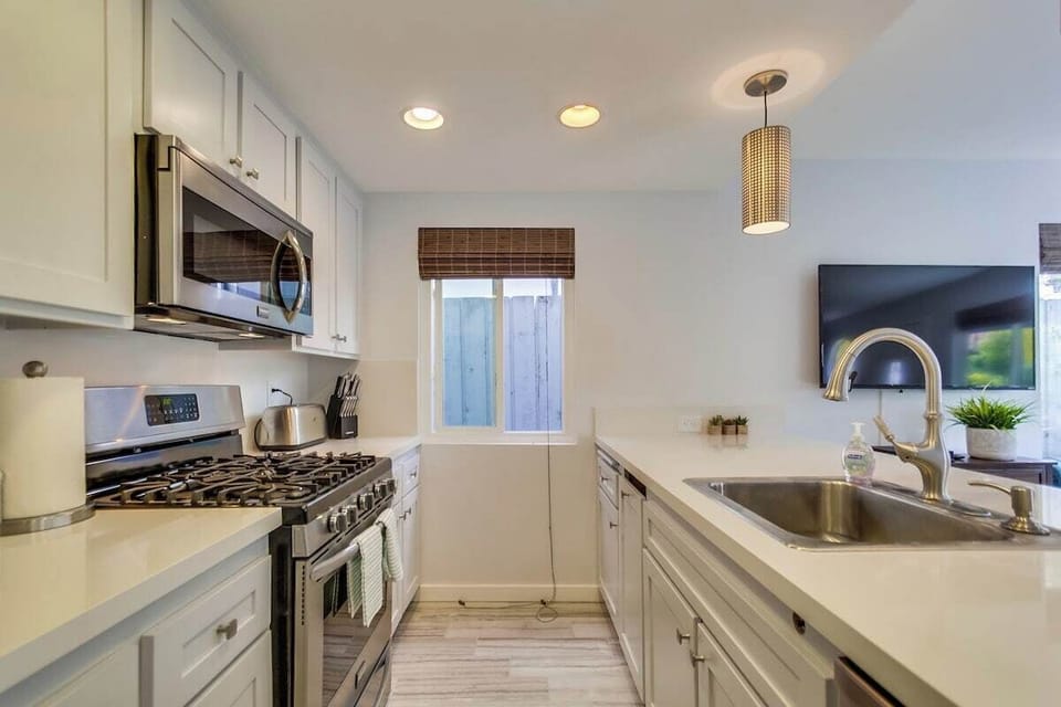 Kitchen with stainless steel appliances, gas stove, sink, toaster, coffee maker, dishwasher