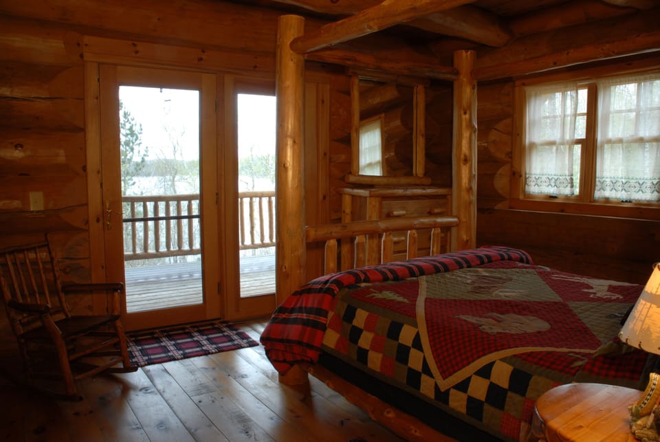 Bedroom with door leading to deck
Overlooking the lake. 