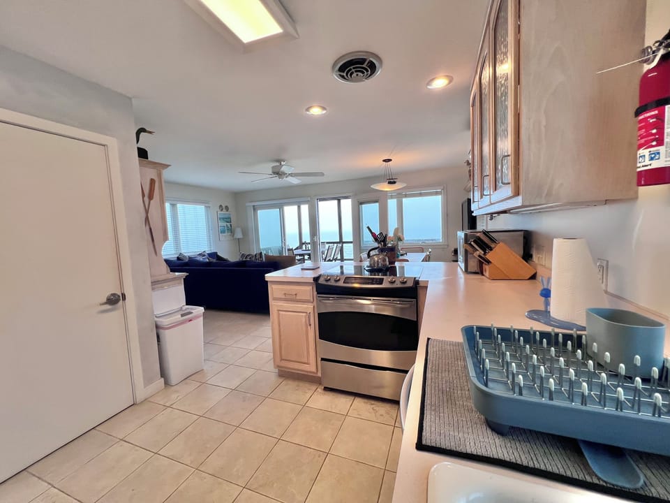 Kitchen Looking To Living Space and Water Facing Deck