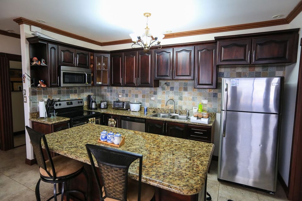 Fully equipped kitchen includes an island and dish-washing machine