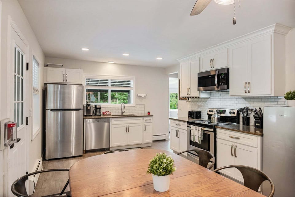 The round table sits beside the renovated kitchen for breakfasts and dinners at home.