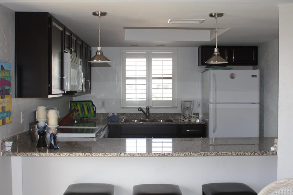 Updated kitchen with granite counters, new dishwasher and new refrigerator.